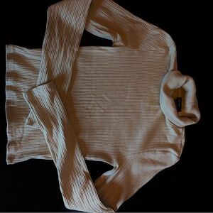 Beige long sleeve turtle neck.